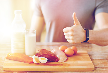 Image showing man with food  rich in protein showing thumbs up