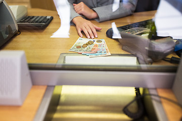 Image showing clerk with cash money at bank office or exchanger