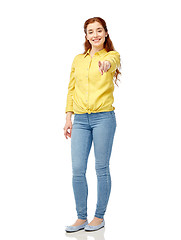 Image showing happy young woman pointing finger on you