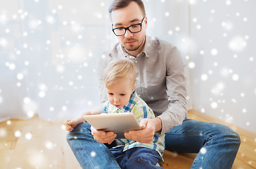 Image showing father and son with tablet pc playing at home