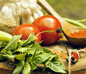 Image showing vegetables on wooden kitchen with spicies, tomato, chilli, green