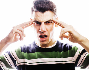 Image showing Portrait of a smart serious young man standing against white background. Emotional concept for gesture