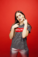 Image showing young pretty emitonal posing teenage girl on bright red background, happy smiling lifestyle people concept