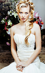 Image showing beauty young bride alone in luxury vintage interior with a lot of flowers close up