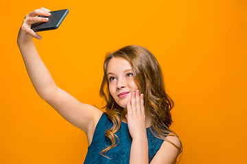 Image showing The face of playful happy teen girl with phone