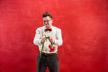 Image showing Young funny man with broken bouquet