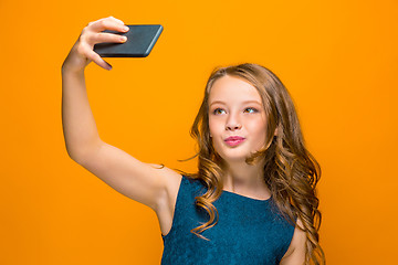 Image showing The face of playful happy teen girl with phone