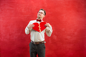 Image showing Young funny man with abstract broken heart