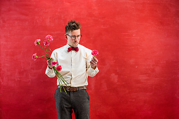 Image showing Young funny man with broken bouquet