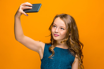 Image showing The face of playful happy teen girl with phone