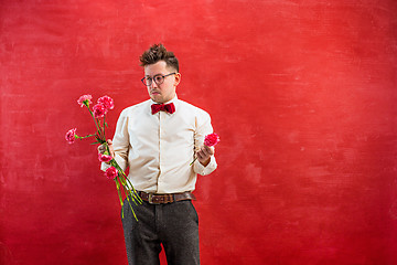 Image showing Young funny man with broken bouquet