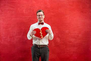 Image showing Young funny man with abstract broken heart