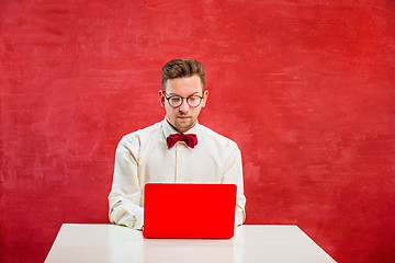 Image showing Young funny man with laptop at St. Valentine\'s Day