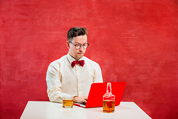 Image showing Young funny man with laptop at St. Valentine\'s Day