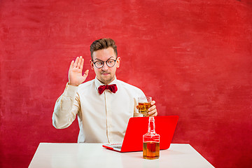 Image showing Young funny man with laptop at St. Valentine\'s Day