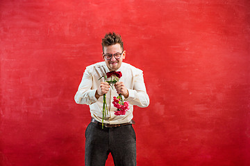 Image showing Young funny man with broken bouquet
