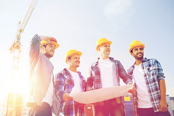 Image showing group of builders with tablet pc and blueprint