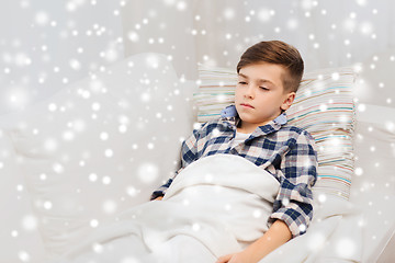 Image showing ill boy with flu lying in bed at home