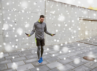 Image showing man exercising with jump-rope outdoors