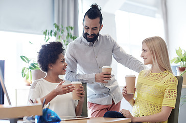 Image showing happy creative team drinking coffee in office