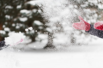 Image showing happy friends playing with snow in winter