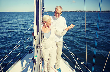 Image showing senior couple hugging on sail boat or yacht in sea