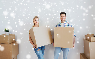 Image showing smiling couple with big boxes moving to new home