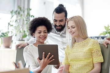 Image showing happy creative team with tablet pc in office