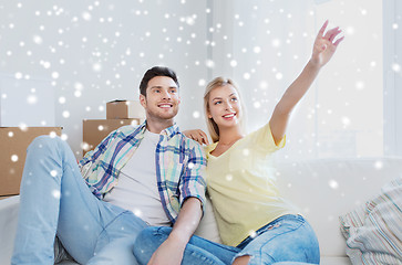 Image showing couple with boxes moving to new home and dreaming