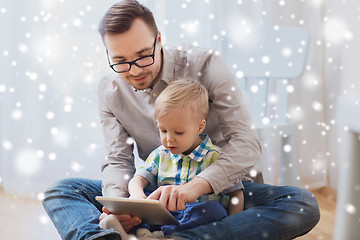 Image showing father and son with tablet pc playing at home