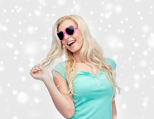 Image showing happy woman or teenager in heart shaped sunglasses