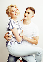 Image showing young pretty teenage couple, hipster guy with his girlfriend happy smiling and hugging isolated on white background, lifestyle people concept