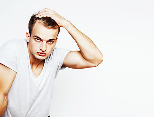 Image showing young handsome man on white background gesturing, pointing, posi