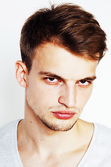 Image showing young handsome man on white background gesturing, pointing, posi