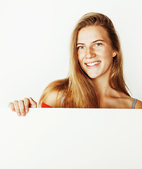 Image showing young pretty blond woman thinking showing to copyspace isolated 