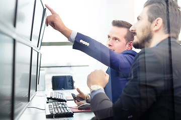 Image showing Stock traders looking at computer screens.