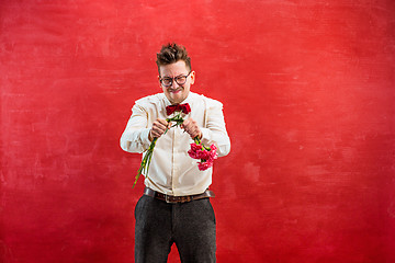 Image showing Young funny man with broken bouquet