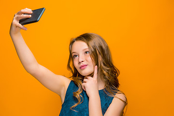 Image showing The face of playful happy teen girl with phone