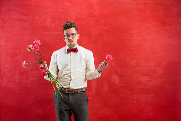 Image showing Young funny man with broken bouquet