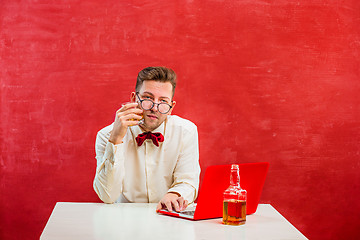 Image showing Young funny man with laptop at St. Valentine\'s Day