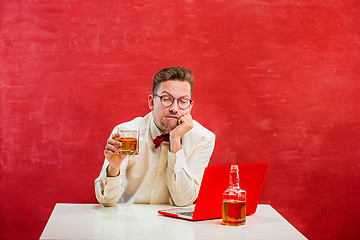 Image showing Young funny man with laptop at St. Valentine\'s Day