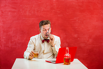 Image showing Young funny man with laptop at St. Valentine\'s Day