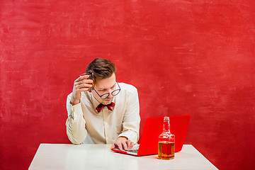 Image showing Young funny man with laptop at St. Valentine\'s Day