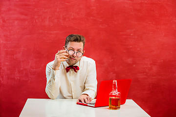 Image showing Young funny man with laptop at St. Valentine\'s Day