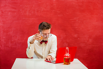 Image showing Young funny man with laptop at St. Valentine\'s Day