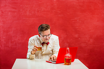 Image showing Young funny man with laptop at St. Valentine\'s Day