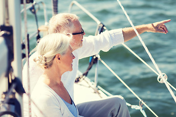 Image showing happy senior couple on sail boat or yacht in sea