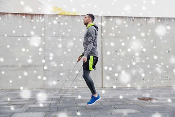 Image showing man exercising with jump-rope outdoors