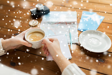 Image showing close up of hands with coffee cup and travel stuff