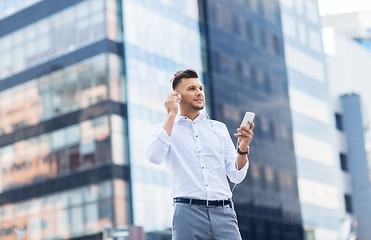 Image showing man with headphones and smartphone listening music